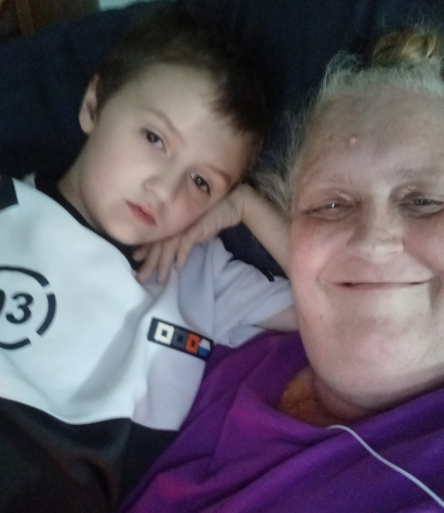 A photo of an elderly woman taking a picture with her young granddaughter.